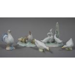 A Nao group of three ducks amidst reeds, 12cm high; a Nao group of hen and chicks on an oval base,