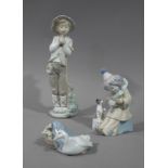 A Nao figure of a young boy clutching a dove,