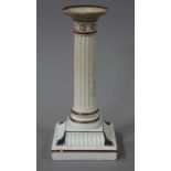 A Wedgwood candlestick of fluted columnar form on fluted square base with moulded foliate corners,