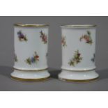 A pair of French miniature cylindrical vases decorated to the bodies with floral sprays within gilt