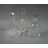 A cut glass ship decanter and stopper; a baluster decanter and stopper,