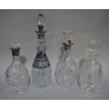 Three decanters with silver collars;