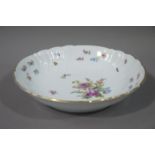 A Haars and Czjzek porcelain shaped circular dish colourfully painted with floral sprays within a