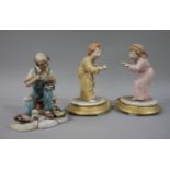 A pair of Naples Capo di Monte figures of young boy and girl with night lights on gilt circular