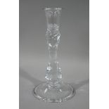 An Edwardian glass candlestick with bucket shaped nozzle spiral pulled waisted stem on circular