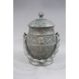 A reproduction Chinese bronze vessel cast with stylised birds and masks on textured bands,