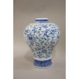 A reproduction Chinese porcelain baluster vase decorated in underglazed blue with stylised flower