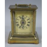 An American brass cased carriage clock the plastic coated paper dial with Roman numerals and