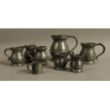 A collection of 19th century pewter baluster measures from a pint to a half quartern and a tapered