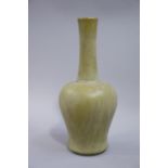 A reproduction Chinese bottle shaped vase the body and tall neck with an olive green glaze,