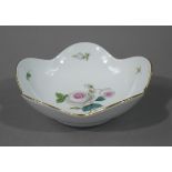 A Meissen shaped circular dish finely painted to the centre with a pink and white rose within bud