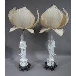 A pair of Chinese Blanc de Chine lamps in the form of a female standing on lotus