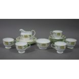 An Aynsley china part tea service decorated with primroses in yellow and green on a white ground,