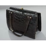 A brown crocodile handbag,