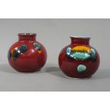 Two Poole pottery globular shaped vases each of blood red colour with orange,