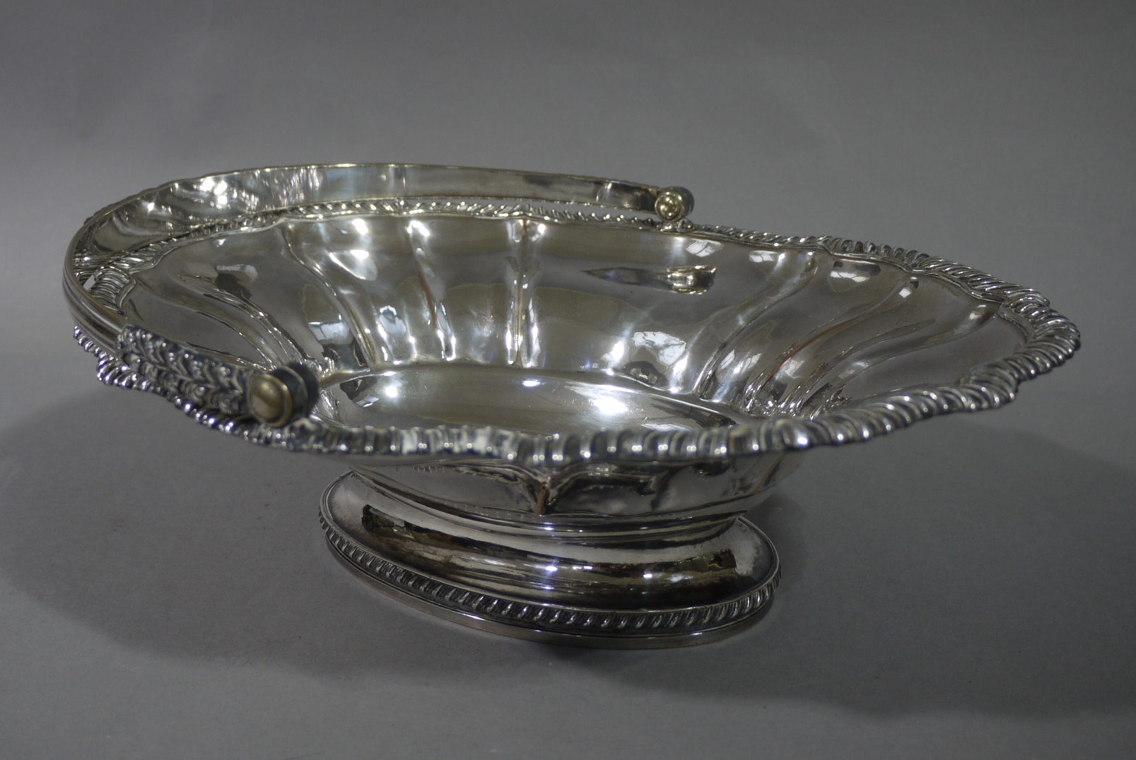 A Victorian Sheffield plate cake basket with reeded acanthus wrapped handle the lobed oval panelled - Image 2 of 3