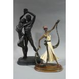 Two reproduction resin figures, one dancing young couple, lightly clad, 60cm high,