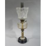 A Victorian brass oil lamp with facetted cut glass reservoir and acid etched shade,