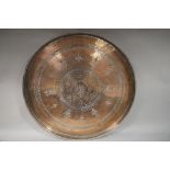 A large copper tray of circular outline and incised with six point star within circle and a