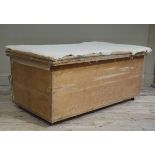 A wooden box with upholstered top, stripped,