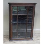 A George III oak hanging corner cupboard with glazed door, panelled sides,