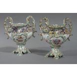 A pair of English porcelain two handled floral encrusted vases of shallow urnular form with waisted