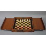 A late 19th century Whittington pattern travelling chess set with polished bone and red stained