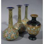 A set of three Doulton Chiné gilt bottle vases with slender necks, blue interiors,