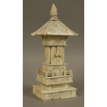 A Japanese Meiji period (1868-1912) ivory pagoda shaped table shrine carved in low relief with