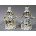 A pair of Meissen style floral encrusted figural candelabrum,