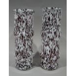 A pair of amethyst and white speckled glass tube vases with a pair of collars,