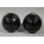 A pair of black glass Christmas baubles,