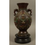 A Chinese and bronze enamelled twin-handled vase cast with bands of motifs against a Greek key