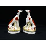 A Pair Of Reproduction Staffordshire Pottery Seated Greyhounds