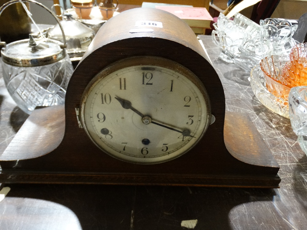 An Early 20th Century Polished Mantel Clock With Circular Silvered Dial