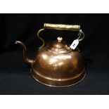 An Antique Circular Based Copper Kettle With Brass Overhead Handle