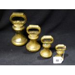 A Set Of Four Brass Bell Weights From 7lb To 1lb