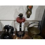 A Circular Bases Brass Column Oil Lamp with Cranberry Reservoir