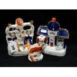 A Staffordshire Pottery Figural Spill Holder Group Together With A Cottage and Single Miniature