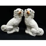 A Pair of Staffordshire Pottery White Seated Dogs