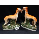 A Pair of Staffordshire Pottery Standing Greyhounds with Prey