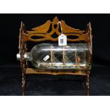 An Antique Ship in A Bottle Named ‘Annie’ And Held Within Oak Folk Art Carved Wooden