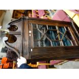 An Antique Oak Single Door Hanging Corner Cupboard