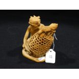 A Finely Carved Wooden Figure Of A Native Feeding A Chicken In A Basket, 5" High