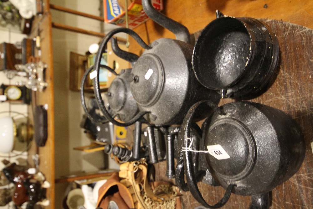 A Collection Of Cast Iron Kettles & Flat Irons