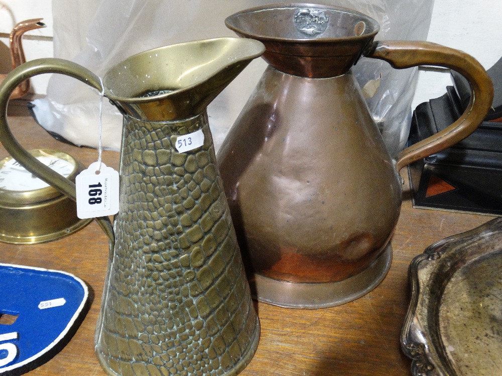 A Circular Based Copper One Gallon Measure Together With A Patterned Brass Jug