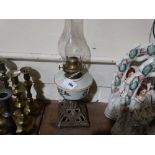 A Metallic Based Oil Lamp With Milk Glass Reservoir
