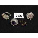 An Amethyst Set Gold Ring, Together With Three White Metal Dress Rings