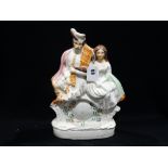 A Staffordshire Pottery Figural Clock Group