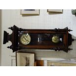 A Victorian Circular Dial Pendulum Wall Clock